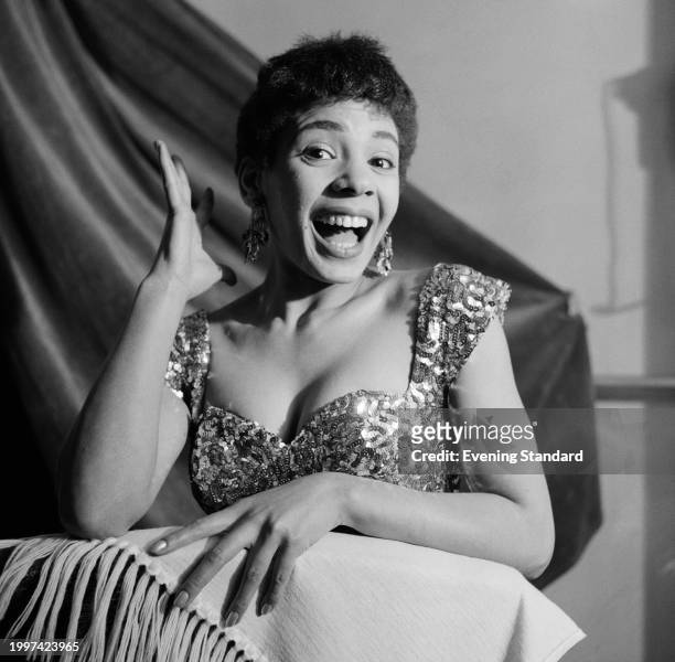 Welsh singer Shirley Bassey gesturing while wearing a sequined dress, January 4th 1956.