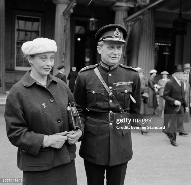 Lieutenant General Sir Hugh Stockwell with his wife, Lady Stockwell, outside Buckingham Palace after the investiture in which he received a Bar to...