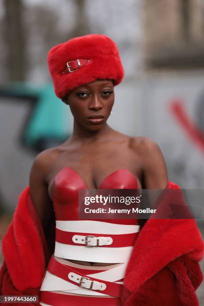 Toni Dreher seen wearing Marina Hoermanseder red belted fake fur fluffy hat, Marina Hoermanseder red / white leather striped belted corset short...