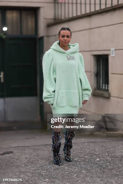 Aminata Belli seen wearing Marina Hoermanseder pastel green pearl embroidered logo teddy fur oversized hoodie / sweater dress, Buffalo x Marina...