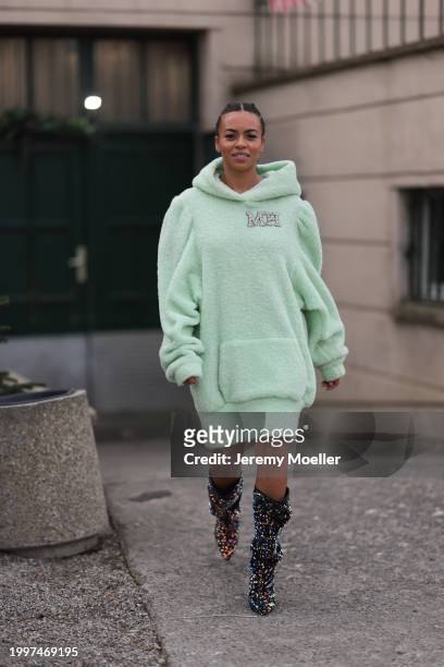 Aminata Belli seen wearing Marina Hoermanseder pastel green pearl embroidered logo teddy fur oversized hoodie / sweater dress, Buffalo x Marina...