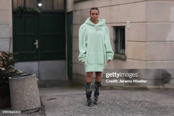 Aminata Belli seen wearing Marina Hoermanseder pastel green pearl embroidered logo teddy fur oversized hoodie / sweater dress, Buffalo x Marina...