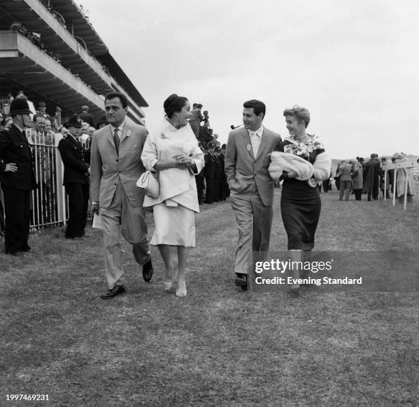 Film producer Mike Todd and his wife, actress Elizabeth Taylor walking with American singer Eddie Fisher and his wife, actress Debbie Reynolds at the...