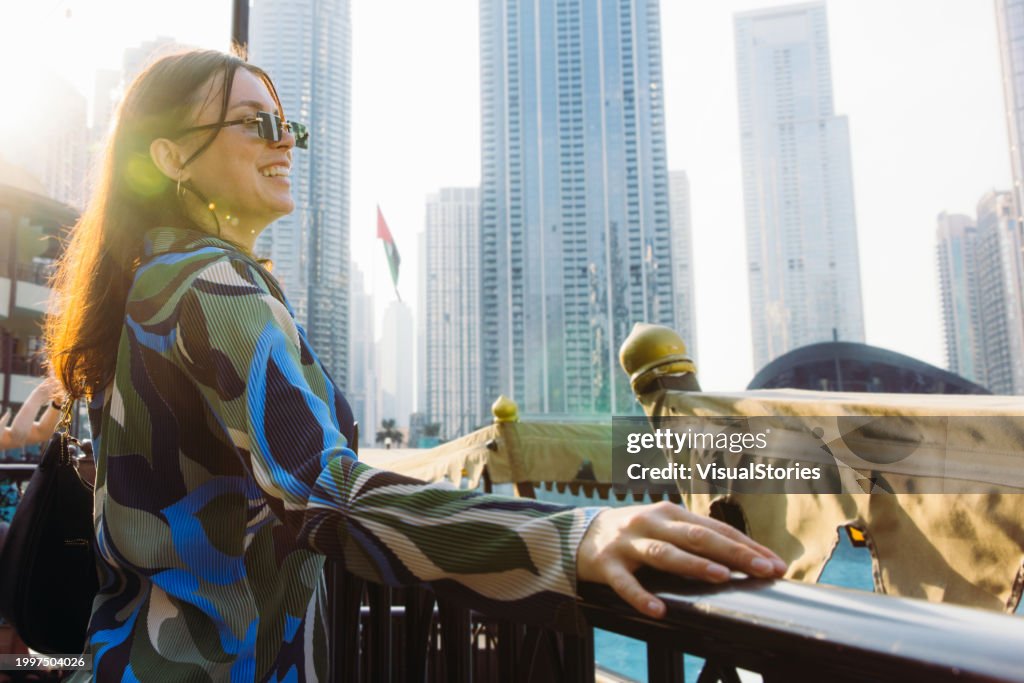 Woman Admiring Scenic Sunset Over Dubai Downtown Skyscrapers