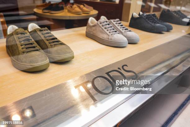 Suede sneakers in the window of a Tod's SpA luxury boutique in central Paris, France, on Monday, Feb. 12, 2024. The founding family of Tod's is...