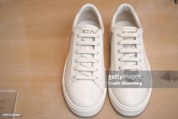 Pair of leather sneakers in the window of a Tod's SpA luxury boutique in central Paris, France, on Monday, Feb. 12, 2024. The founding family...