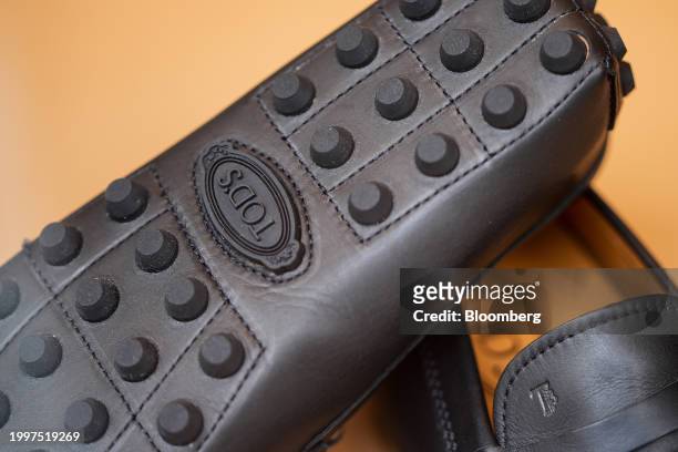 Logo on the rubber outsole of a pair of leather loafers in the window of a Tod's SpA luxury boutique in central Paris, France, on Monday, Feb. 12,...