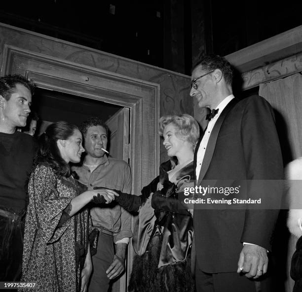 Actress Marilyn Monroe and her husband, playwright Arthur Miller visit the cast of Miller's play 'A View from the Bridge', from left: Ian Bannen ,...