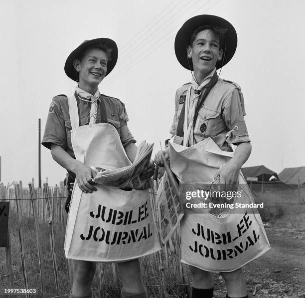 Boy Scouts Keith Thom and Clive Sprasson carry satchels filled with the 'Jubilee Journal' during the 9th World Scout Jamboree, Sutton Park, Sutton...