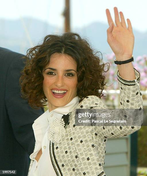 Actress Penelope Cruz waves goodbye to the photographers during a photocall for the film Fan Fan La Tulipe at the Palais des Festivals during the...