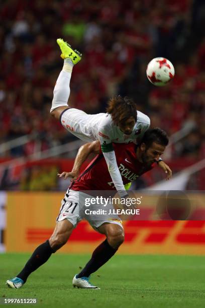 Zlatan Ljubijankic of Urawa Red Diamonds and Kosuke Kikuchi of Omiya Ardija compete for the ball during the J.League J1 match between Urawa Red...