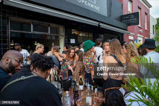 South Africans enjoy a glass of wine and a jazz jam session at the Openwine wine bar on January 28, 2024 in trendy downtown Cape Town, South Africa....