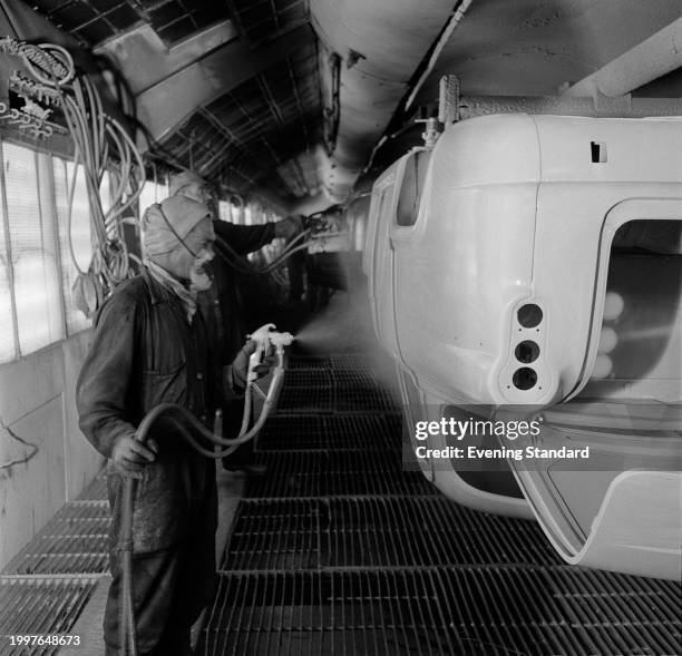 Worker sprays a car in the paint shop at the BMC Austin Longbridge car plant, Birmingham, June 26th 1957.