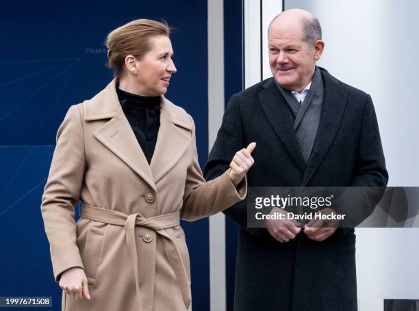 Danish Prime Minister Mette Frederiksen talks to German Chancellor Olaf Scholz after the groundbreaking ceremony for a new munitions factory of...