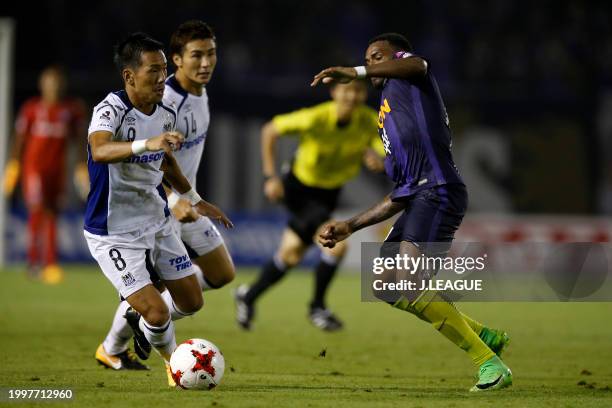 Yosuke Ideguchi of Gamba Osaka controls the ball against Anderson Lopes of Sanfrecce Hiroshima during the J.League J1 match between Sanfrecce...