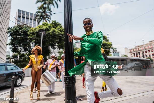 portrait of a young man having fun and dancing at a street carnival party - rio de janeiro party stock pictures, royalty-free photos & images