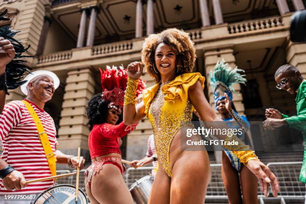 portrait of a mid adult woman having fun and dancing at a street carnival party - school fondsenwervingsfeest stockfoto's en -beelden