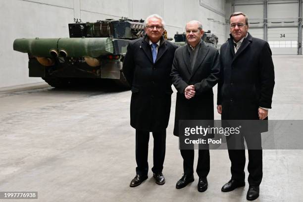German Chancellor Olaf Scholz , German Defence Minister Boris Pistorius and CEO of Rheinmetall Armin Papperger pose by Leopard 2 tanks as they attend...