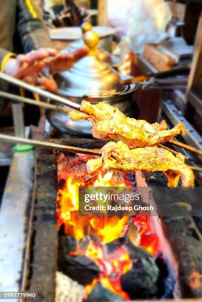 chicken tandoori getting prepared on iron sheek - indian food stock pictures, royalty-free photos & images