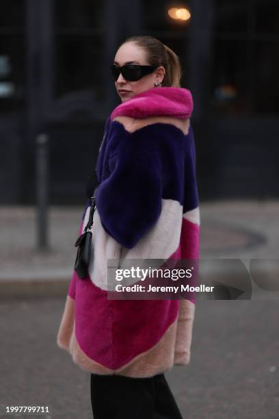 Sonia Lyson seen wearing & Other Stories black sunglasses, silver earrings, Marina Hoermanseder pink / purple / white / beige fake fur hooded short...