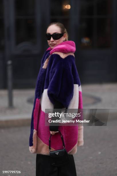 Sonia Lyson seen wearing & Other Stories black sunglasses, silver earrings, Marina Hoermanseder pink / purple / white / beige fake fur hooded short...