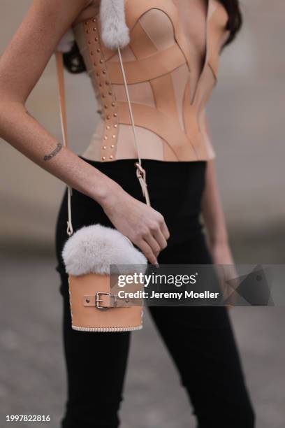 Celine Bethmann seen wearing Marina Hoermanseder beige corset with low neckline, Marina Hoermanseder beige leather / white fur detailed bucket bag,...