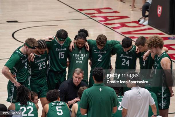 Dartmouth Big Green players huddle around head coach David McLaughlin before the college basketball game between the Dartmouth Big Green and the...