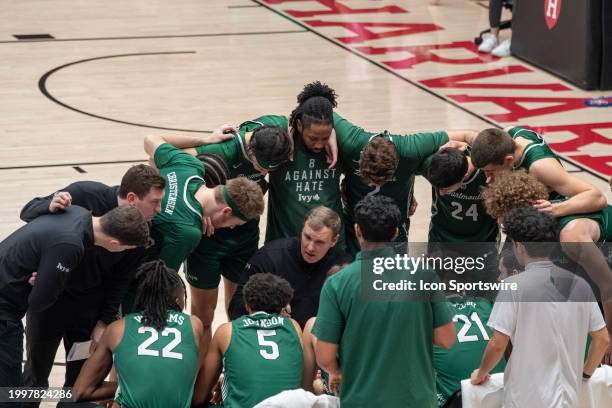 Dartmouth Big Green players huddle around head coach David McLaughlin before the college basketball game between the Dartmouth Big Green and the...