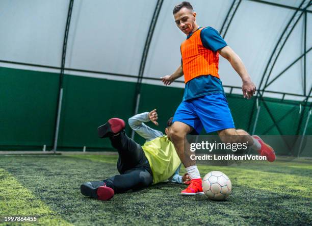 soccer player trying to block rival to score a goal - fault sports stock pictures, royalty-free photos & images