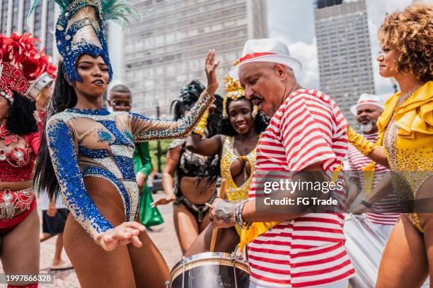 people having fun at a street carnival party - carnival dancers stock pictures, royalty-free photos & images