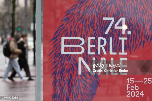 People walk past posters for the 2024 Berlinale Berlin International Film Festival ahead of the 74th Berlinale International Film Festival Berlin on...