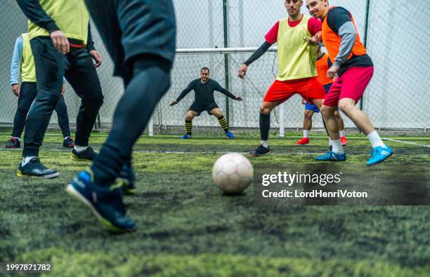 soccer player kicking ball at goal - defending activity stock pictures, royalty-free photos & images