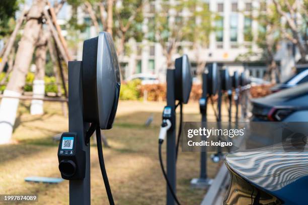 urban outdoor electric vehicle charging station - sustainable transport stock pictures, royalty-free photos & images