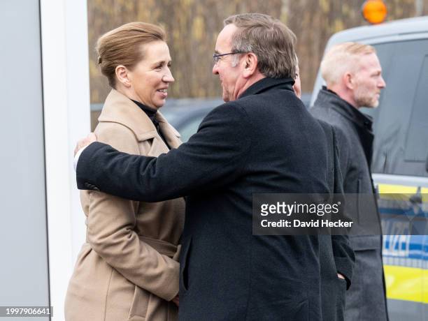 Danish Prime Minister Mette Frederiksen and German Defence Minister Boris Pistorius hug each other after the groundbreaking ceremony for a new...