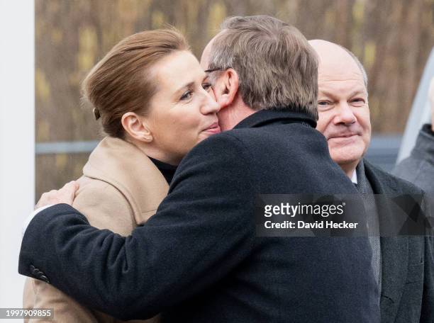 Danish Prime Minister Mette Frederiksen and German Defence Minister Boris Pistorius hug each other attended by German Chancellor Olaf Scholz after...