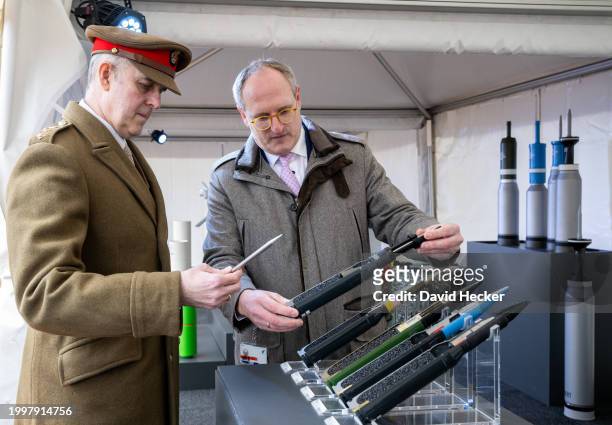 Rheinmetall employee shows ammunition for German Gepard anti-aircraft-gun tank to an officer of the British Army before the groundbreaking ceremony...