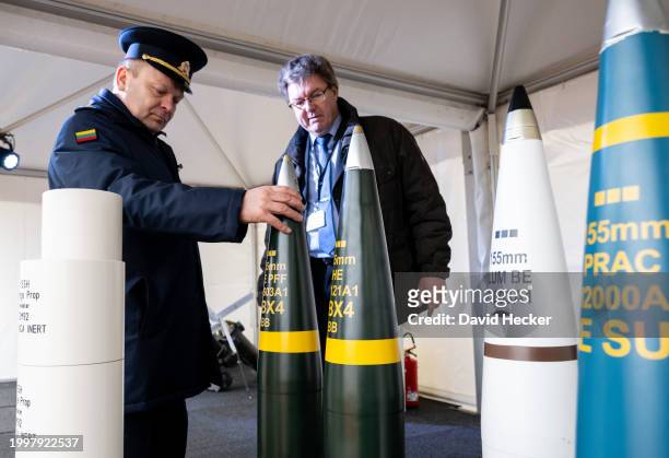 Rheinmetall employee shows artillery ammunition to an officer of Lithuanian Army before the groundbreaking ceremony for a new munitions factory of...