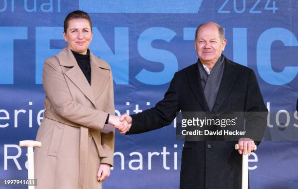 Danish Prime Minister Mette Frederiksen and German Chancellor Olaf Scholz shake hands during the groundbreaking ceremony for a new munitions factory...