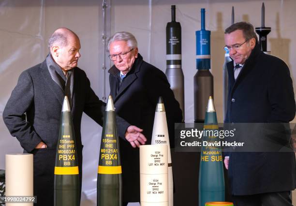 German Chancellor Olaf Scholz , CEO of Rheinmetall Armin Papperger and German Defence Minister Boris Pistorius with artillery ammunition before the...