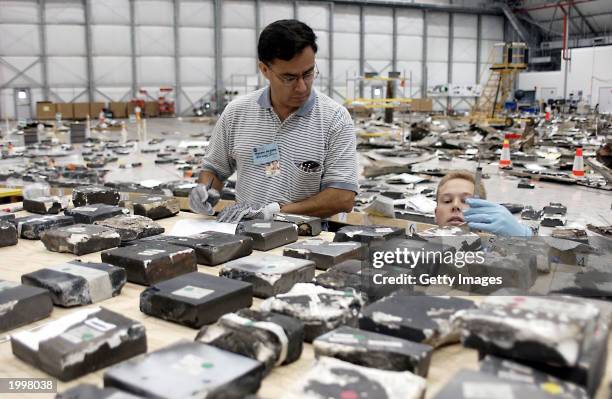 In this handout photo by NASA, members of the Columbia Reconstruction Project Team continue to examine and identify pieces of debris from the Space...