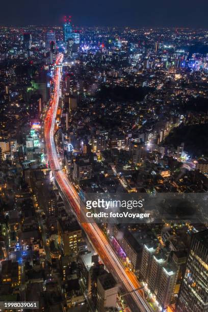 tokyo aerial cityscape over neon night highway crowded skyscrapers japan - roppongi stock pictures, royalty-free photos & images