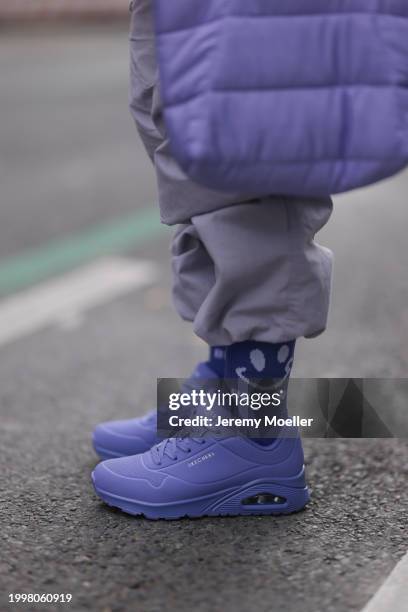 Palina Kozyrava seen wearing pastel purple nylon cargo pants, Vertere purple cotton logo smiley print pattern socks, purple nylon quilted bag and...