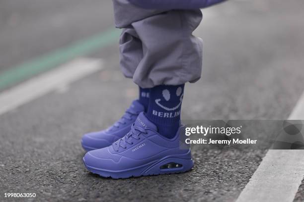 Palina Kozyrava seen wearing pastel purple nylon cargo pants, Vertere purple cotton logo smiley print pattern socks and Skechers purple leather...