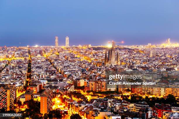 barcelona cityscape illuminated at dusk, catalonia, spain - spanish culture stock pictures, royalty-free photos & images