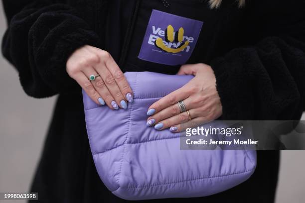 Palina Kozyrava seen wearing Vertere black logo patch fleece jacket, purple nylon quilted bag, silver / gold rings, on February 08, 2024 in Berlin,...