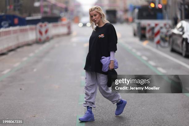 Palina Kozyrava seen wearing Vertere black logo pattern cap, Vertere black logo print pattern cotton t-shirt, pastel purple nylon cargo pants,...