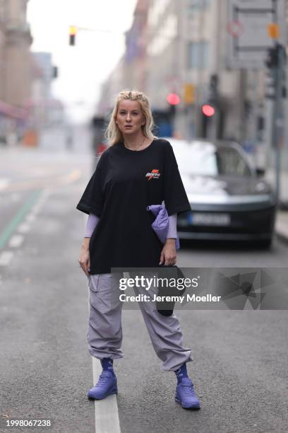 Palina Kozyrava seen wearing Vertere black logo pattern cap, Vertere black logo print pattern cotton t-shirt, pastel purple nylon cargo pants,...