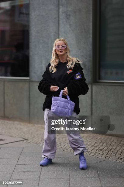 Palina Kozyrava seen wearing purple transparent sunglasses, Vertere black logo patch fleece jacket, Vertere black logo print pattern cotton t-shirt,...