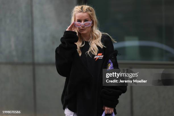 Palina Kozyrava seen wearing purple transparent sunglasses, Vertere black logo patch fleece jacket, Vertere black logo print pattern cotton t-shirt,...