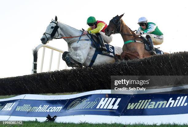 Meath , Ireland - 11 February 2024; Young Dev, left, with Daniel King up, jumps the last on their way to winning the William Hill Handicap...